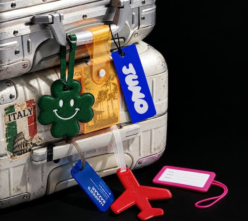 A well travelled suitcase covered in luggage tags, one of them Juno's